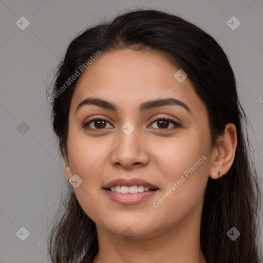 Joyful latino young-adult female with long  brown hair and brown eyes