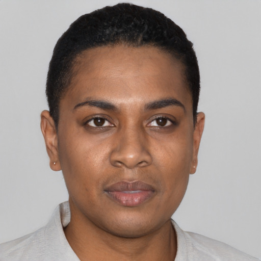 Joyful black young-adult female with short  black hair and brown eyes
