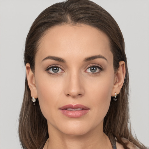 Joyful white young-adult female with long  brown hair and grey eyes