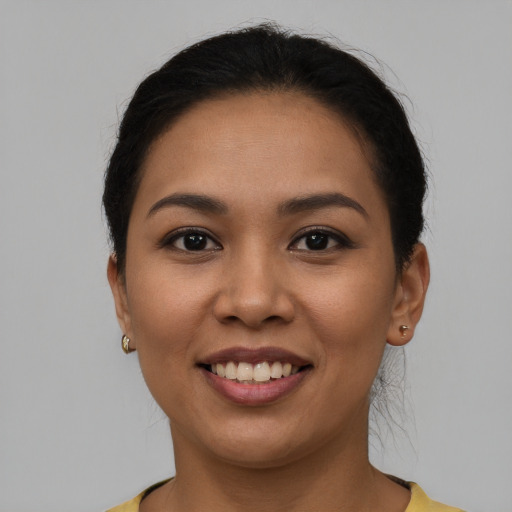 Joyful latino young-adult female with short  brown hair and brown eyes