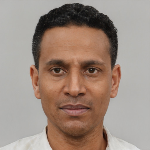 Neutral latino adult male with short  black hair and brown eyes