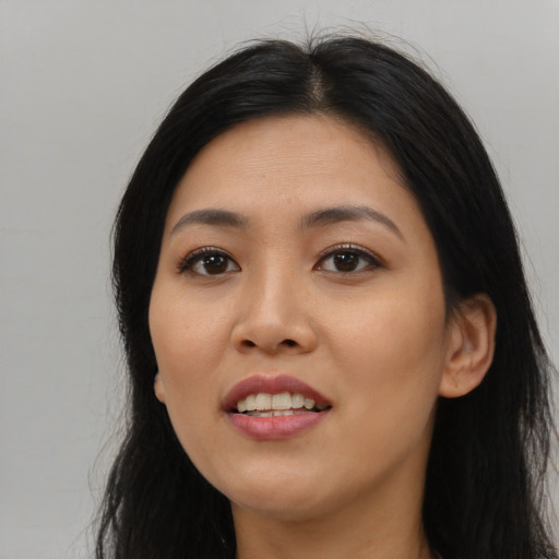 Joyful asian young-adult female with long  black hair and brown eyes