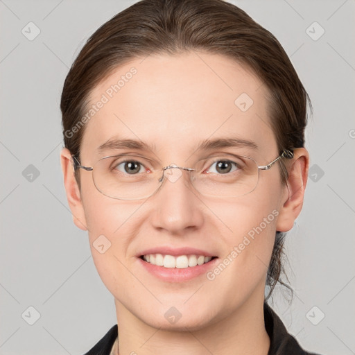 Joyful white young-adult female with short  brown hair and grey eyes