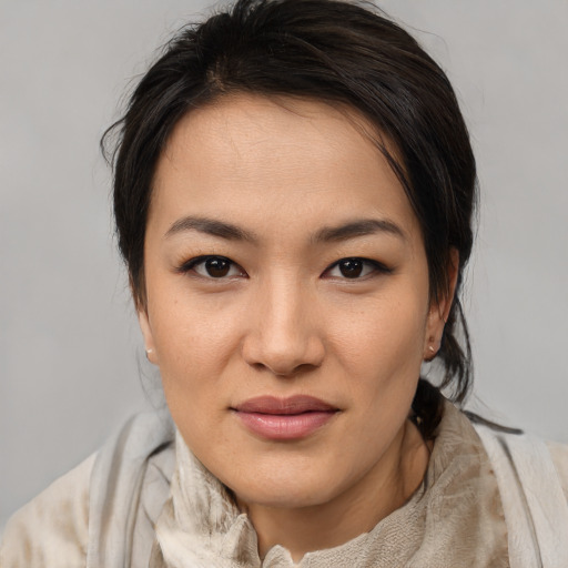 Joyful asian young-adult female with medium  brown hair and brown eyes