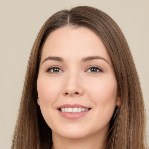 Joyful white young-adult female with long  brown hair and brown eyes