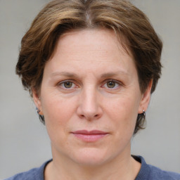 Joyful white adult female with medium  brown hair and grey eyes