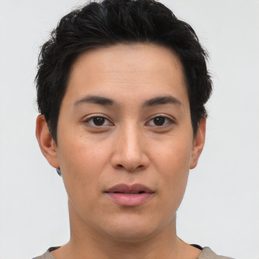 Joyful asian young-adult female with short  brown hair and brown eyes