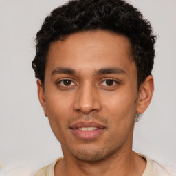 Joyful latino young-adult male with short  brown hair and brown eyes