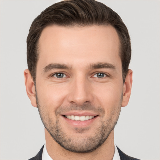 Joyful white young-adult male with short  brown hair and brown eyes