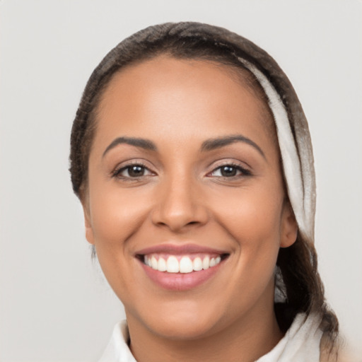 Joyful latino young-adult female with long  brown hair and brown eyes