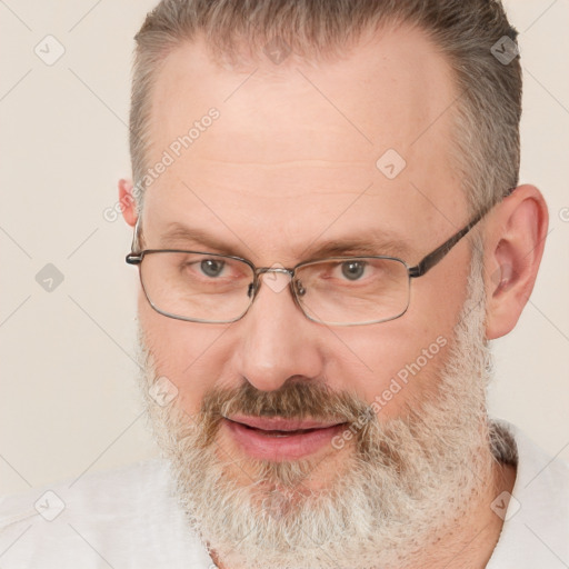 Joyful white middle-aged male with short  brown hair and brown eyes