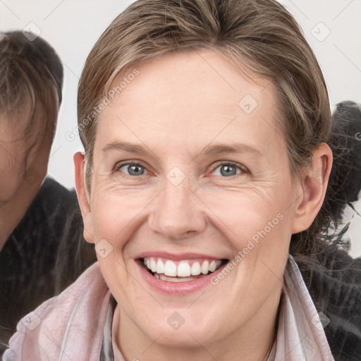 Joyful white adult female with medium  brown hair and grey eyes