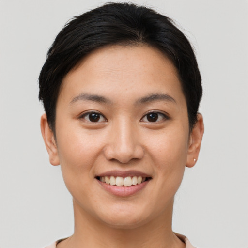 Joyful asian young-adult female with short  brown hair and brown eyes
