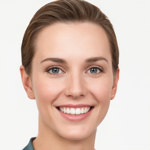 Joyful white young-adult female with short  brown hair and grey eyes