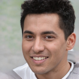 Joyful white young-adult male with short  black hair and brown eyes