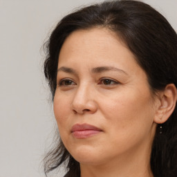 Joyful white adult female with long  brown hair and brown eyes