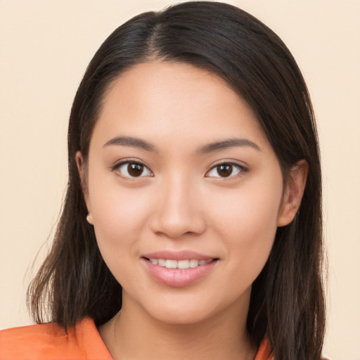 Joyful asian young-adult female with long  brown hair and brown eyes