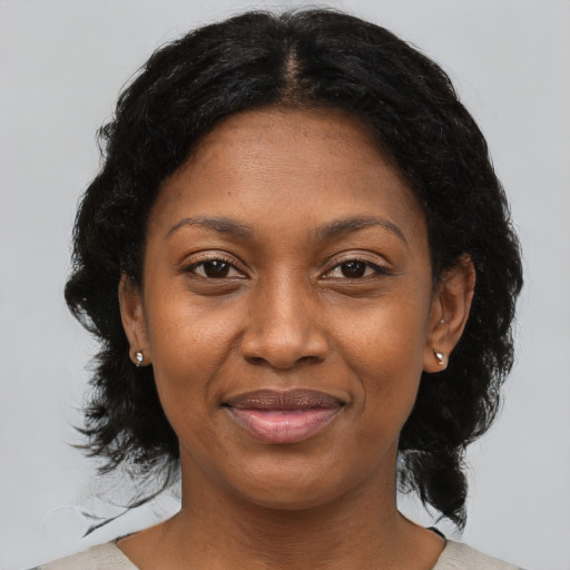 Joyful black adult female with medium  black hair and brown eyes