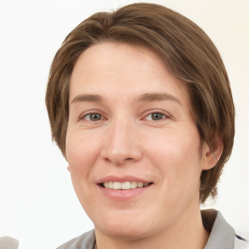 Joyful white young-adult female with short  brown hair and grey eyes