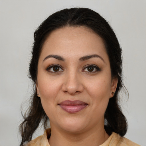Joyful latino young-adult female with medium  brown hair and brown eyes