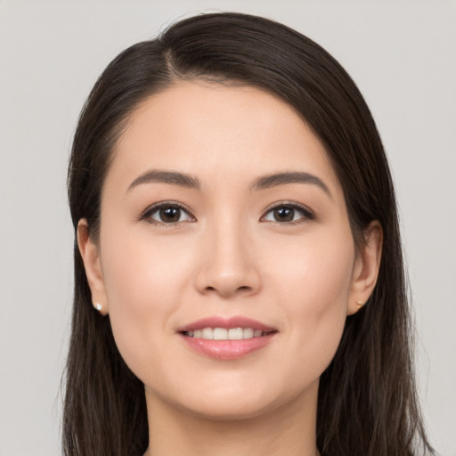 Joyful white young-adult female with long  brown hair and brown eyes