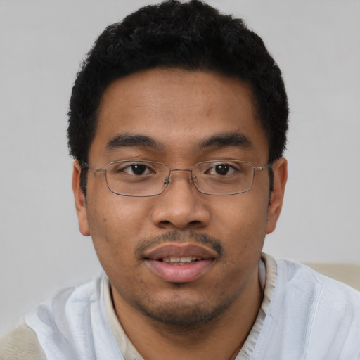 Joyful latino young-adult male with short  brown hair and brown eyes