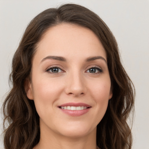 Joyful white young-adult female with long  brown hair and green eyes