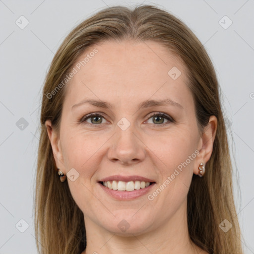 Joyful white adult female with long  brown hair and grey eyes