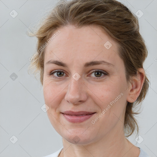 Joyful white adult female with medium  brown hair and brown eyes