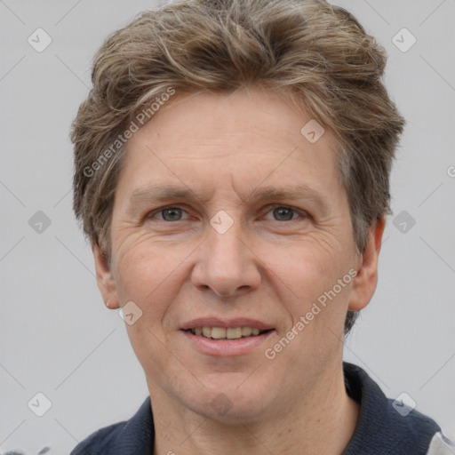 Joyful white adult male with short  brown hair and grey eyes