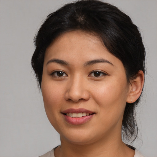 Joyful asian young-adult female with medium  brown hair and brown eyes