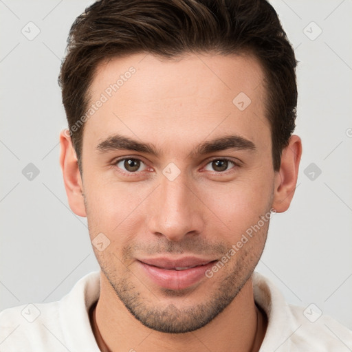 Joyful white young-adult male with short  brown hair and brown eyes