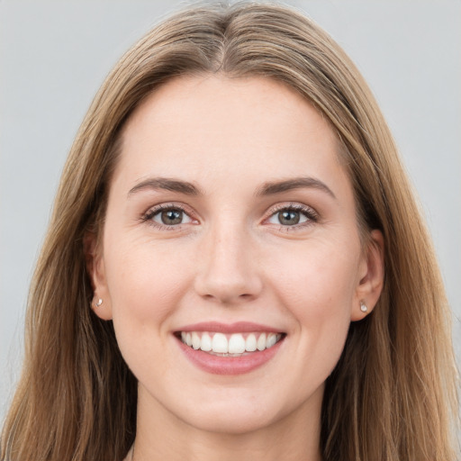 Joyful white young-adult female with long  brown hair and grey eyes