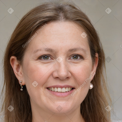 Joyful white adult female with long  brown hair and grey eyes