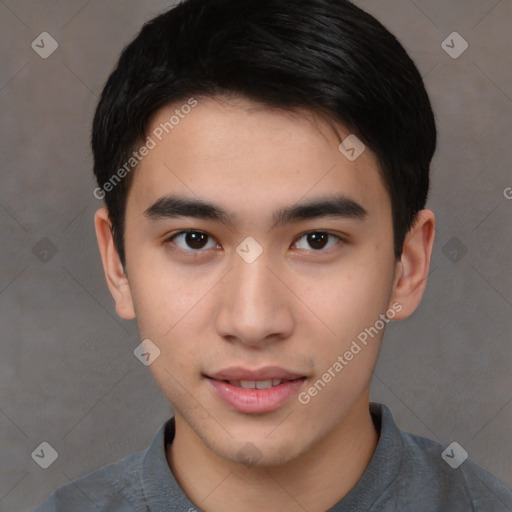 Joyful asian young-adult male with short  brown hair and brown eyes