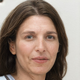 Joyful white adult female with long  brown hair and grey eyes