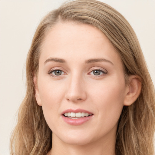 Joyful white young-adult female with long  brown hair and grey eyes