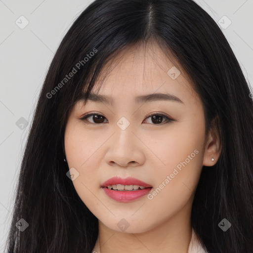 Joyful asian young-adult female with long  black hair and brown eyes