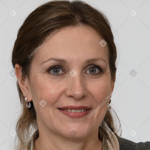 Joyful white adult female with medium  brown hair and grey eyes