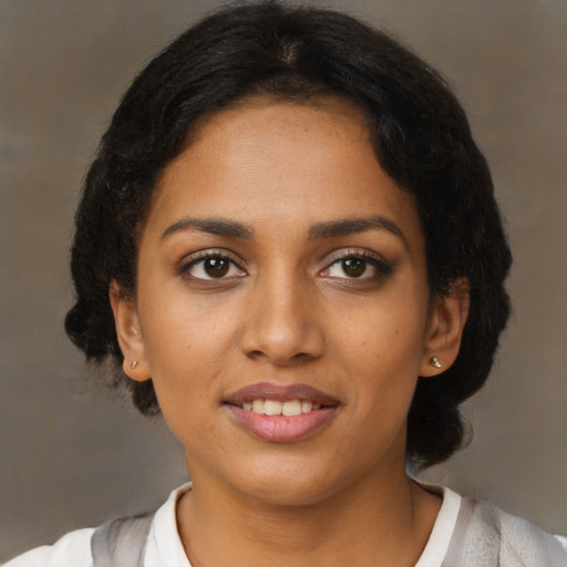 Joyful black young-adult female with medium  brown hair and brown eyes