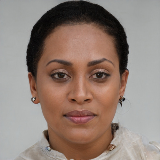 Joyful black young-adult female with short  brown hair and brown eyes