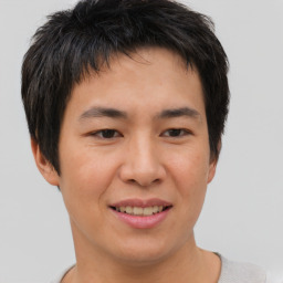 Joyful asian young-adult male with short  brown hair and brown eyes