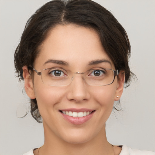 Joyful white adult female with medium  brown hair and brown eyes