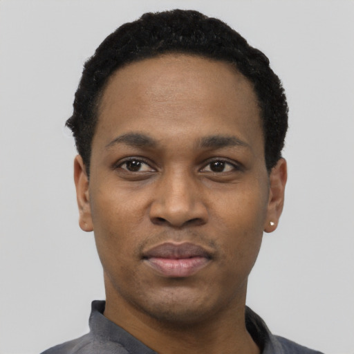 Joyful black young-adult male with short  black hair and brown eyes