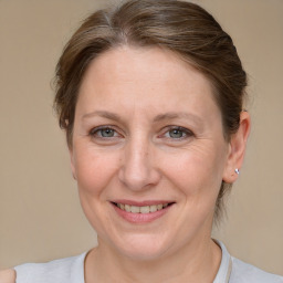 Joyful white adult female with medium  brown hair and grey eyes