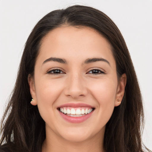 Joyful white young-adult female with long  brown hair and brown eyes