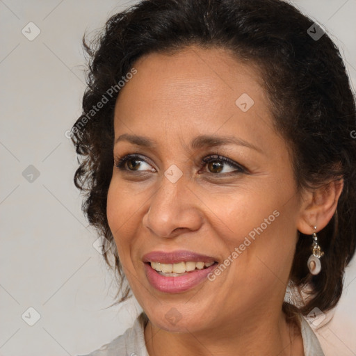 Joyful black adult female with medium  brown hair and brown eyes