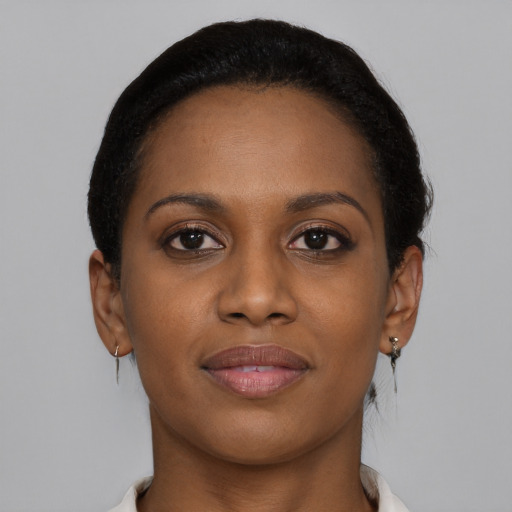 Joyful black young-adult female with short  brown hair and brown eyes