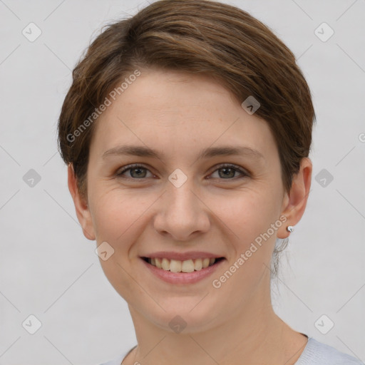 Joyful white young-adult female with short  brown hair and grey eyes