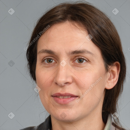 Joyful white adult female with medium  brown hair and brown eyes